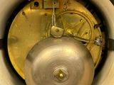 a close up view of a clock with a yellow dial