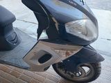 a scooter that is parked on the side of the street