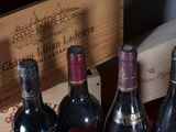 several bottles of wine are lined up in a row on a table
