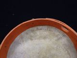 a close up view of a drum with a black background