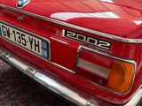 a red car that is parked on a rug