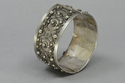 a close up of a silver ring on a gray surface