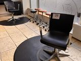 an image of a salon with a chair and a mirror