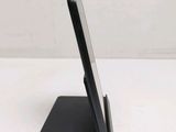 a cell phone that is on a stand on the table