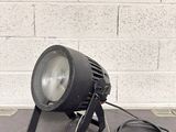 a light that is sitting on a table next to a brick wall