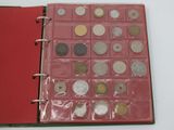 a red book with a bunch of coins inside of it