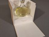 a bottle of perfume sitting in a box on a table