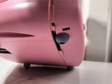 a pink piece of luggage sitting on top of a table