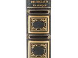 an old black book with gold trimmings and gold trimmings