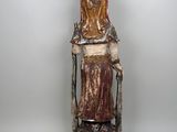 an image of a statue of a woman sitting on a chair