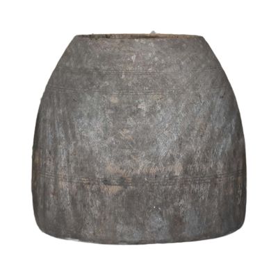 a large gray vase that is sitting on a white surface