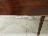 a table with a wooden top on a cement floor