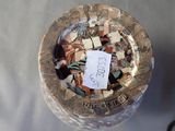 a glass jar with a tag on it that has broken pieces of glass in it