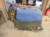 a blue machine that is sitting in a garage