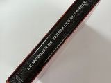 a close up of a tube of mascara on a white surface