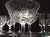 several empty wine glasses sitting on a table with a black background