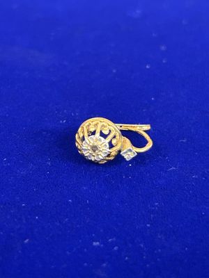 un gros plan d'une bague en or sur une surface bleue