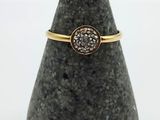 a close up of a ring on a rock with a white background