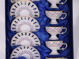 an image of a set of tea cups and saucers in a blue box