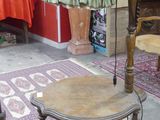 a table with a lamp on it in the middle of a room