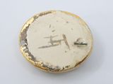 a gold and white brooch with the letter h on it