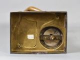 a brass clock that is sitting on a table