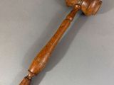 a wooden gaven with a wooden handle on a gray surface