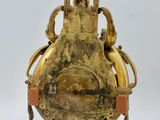 an image of a gold vase hanging from a chain on a white background