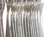 a lot of forks that are sitting on a table