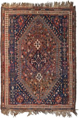 an antique persian rug with a geometric design and fringe fringes