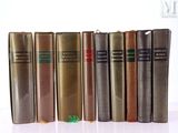 books are lined up in a row on a white surface