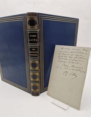 a blue book with writing on it next to a piece of paper