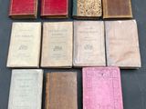 several old books sitting on top of a table next to each other