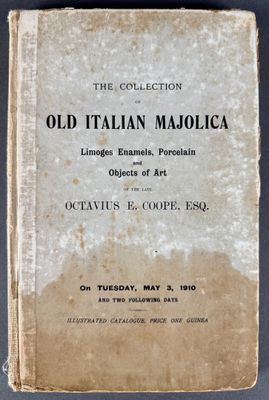 an old italian majolica book sitting on top of a table