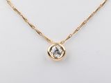 a gold plated necklace with a clear crystal stone on a gold chain