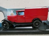 une maquette de camion rouge posée sur un socle noir