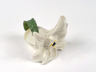 porcelain figurine of a white flower with a green leaf