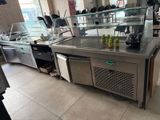a counter with a bunch of drinks on it in a restaurant