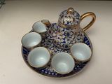 a blue and white tea set on a plate