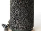 a close up of a bird feeder on a white surface