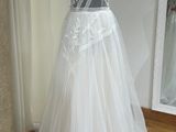 a dress on a mannequin stand in front of a mirror