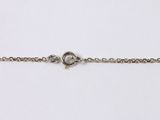 a close up of a silver chain with a heart on it
