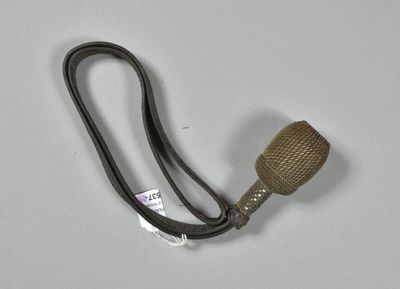 a metal pipe with a wooden handle on a white surface