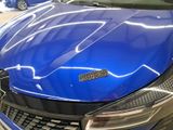 a close up of a shiny blue car in a showroom