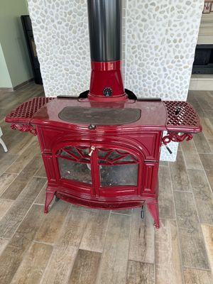 a red stove sitting in the middle of a living room