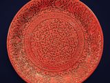 an image of a red plate with a design on it