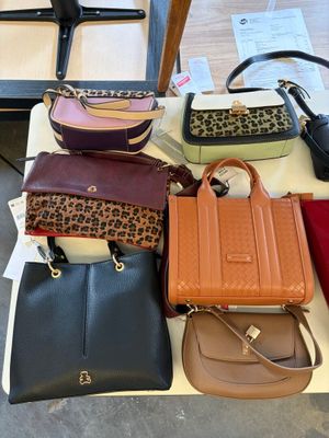 a lot of purses that are on a table