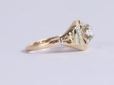 a close up of a diamond ring on a white surface