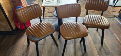 four chairs that are sitting in a room
