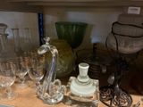 a shelf with a lot of glasses and vases on it